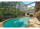 Private pool with screened enclosure and lush landscaping for a tranquil backyard oasis at 639 Elwood St, Deltona, FL 32725