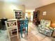 Dining area featuring rustic furniture, unique decor, and an open layout with tile flooring at 670 W Tall Pine Ter, Deland, FL 32724