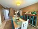 Cozy dining room featuring a unique wood table, colorful chairs, and bright, eye-catching decor at 670 W Tall Pine Ter, Deland, FL 32724