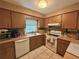 Well-maintained kitchen with tile flooring, white appliances, and plenty of counter space for meal prep at 670 W Tall Pine Ter, Deland, FL 32724