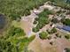 Aerial view of the home, equestrian facilities and the mature trees on the property at 685 Enterprise Osteen Rd, Osteen, FL 32764