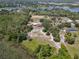 Spacious aerial view features the home, pond, horse paddock and water views, all surrounded by lush greenery at 685 Enterprise Osteen Rd, Osteen, FL 32764