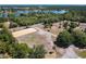 Aerial view showcasing the equestrian arena alongside lush landscaping and nearby lakes at 685 Enterprise Osteen Rd, Osteen, FL 32764