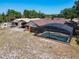 Backyard oasis featuring a refreshing pool, perfect for relaxing, complemented by lush landscape views and additional parking areas at 685 Enterprise Osteen Rd, Osteen, FL 32764