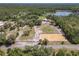Estate featuring horse arena, detached garage, and a private pond amid lush greenery at 685 Enterprise Osteen Rd, Osteen, FL 32764