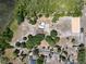 Aerial shot of the property with equestrian facilities, home, and a vast expanse of trees at 685 Enterprise Osteen Rd, Osteen, FL 32764