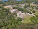 Aerial view of a property with open space, lush trees, and a home including a horse paddock nearby at 685 Enterprise Osteen Rd, Osteen, FL 32764