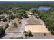 Scenic aerial view of a property with a home, horse arena, and serene lake, surrounded by nature at 685 Enterprise Osteen Rd, Osteen, FL 32764