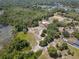 Aerial view showcasing the house, horse paddock and pond amongst abundant green space and mature trees at 685 Enterprise Osteen Rd, Osteen, FL 32764