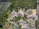 Overhead view of a property featuring a pond, lush trees, and a residence with ample surrounding space at 685 Enterprise Osteen Rd, Osteen, FL 32764