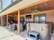 A covered back patio features comfortable seating, a hot tub, and an outdoor fan at 685 Enterprise Osteen Rd, Osteen, FL 32764