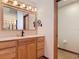 Bathroom vanity with modern faucets, large decorative mirror, and open doorway leading to more house interior at 685 Enterprise Osteen Rd, Osteen, FL 32764