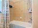Clean bathroom with a shower featuring tiled walls, a shower curtain, and accessories at 685 Enterprise Osteen Rd, Osteen, FL 32764