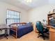 Bright bedroom showcasing a daybed, a desk and workstation illuminated by natural light from a large window at 685 Enterprise Osteen Rd, Osteen, FL 32764