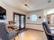 Cozy dining area featuring a round table, stylish chairs, and access to the outdoor area via glass doors at 685 Enterprise Osteen Rd, Osteen, FL 32764