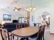 Dining room featuring a wood table with seating, neutral walls, and brick fireplace in the background at 685 Enterprise Osteen Rd, Osteen, FL 32764