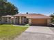 Charming brick home with a well-manicured lawn and attached two-car garage at 685 Enterprise Osteen Rd, Osteen, FL 32764