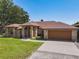 Charming single-story brick home boasts an attached two-car garage and lush lawn at 685 Enterprise Osteen Rd, Osteen, FL 32764