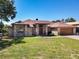 Charming brick home with a well-manicured lawn and attached two-car garage at 685 Enterprise Osteen Rd, Osteen, FL 32764