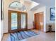Inviting foyer with decorative glass double doors, tile flooring, and a high ceiling with a statement chandelier at 685 Enterprise Osteen Rd, Osteen, FL 32764
