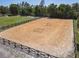 Well-maintained horse arena surrounded by a black fence and mature trees at 685 Enterprise Osteen Rd, Osteen, FL 32764