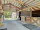 Interior of a well-maintained horse stable with wooden stalls and ample space for equipment storage at 685 Enterprise Osteen Rd, Osteen, FL 32764