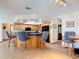 Open kitchen with barstool seating, wood cabinets, neutral tile flooring and modern appliances at 685 Enterprise Osteen Rd, Osteen, FL 32764