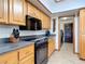 Kitchen featuring wooden cabinets, black appliances, and a sleek cooktop for culinary enthusiasts at 685 Enterprise Osteen Rd, Osteen, FL 32764