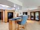 Open-concept living area with bar-style seating and tiled flooring at 685 Enterprise Osteen Rd, Osteen, FL 32764