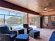 Screened-in lanai with covered patio area, ceiling fan, and comfortable seating overlooking a pool at 685 Enterprise Osteen Rd, Osteen, FL 32764