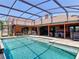 Screened-in pool area with outdoor seating, grill, and hot tub for relaxing and entertaining at 685 Enterprise Osteen Rd, Osteen, FL 32764