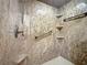 Luxurious shower featuring marbled walls, built-in shelves and bronze fixtures offering a spa-like experience at 685 Enterprise Osteen Rd, Osteen, FL 32764