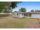 Wide view of back exterior featuring a large grass area, landscaping and privacy fence at 732 Mockingbird Ln, Deland, FL 32720