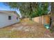 Backyard with a privacy fence, large tree, and green lawn at 732 Mockingbird Ln, Deland, FL 32720