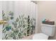 Bright bathroom featuring a shower curtain, toilet, and gold hardware at 732 Mockingbird Ln, Deland, FL 32720