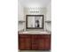 Bathroom showcasing a double vanity with granite countertop and decorative mirror, offering elegance and functionality at 732 Mockingbird Ln, Deland, FL 32720