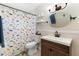 bathroom with a modern sink and vanity, and a whimsical dinosaur themed shower curtain at 732 Mockingbird Ln, Deland, FL 32720