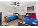 Charming bedroom featuring matching beds, decor, ceiling fan and laminate flooring at 732 Mockingbird Ln, Deland, FL 32720