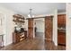 Inviting dining area features a custom coffee bar, wooden floors, and stylish barn door to the living room at 732 Mockingbird Ln, Deland, FL 32720