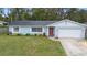Well-maintained single-story home with a lush green lawn and traditional architectural details at 732 Mockingbird Ln, Deland, FL 32720