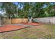 Playground in landscaped backyard featuring mulch and stone at 732 Mockingbird Ln, Deland, FL 32720