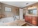 Bathroom featuring a soaking tub, wood vanity, tile floor, and neutral paint at 795 Superior St, Deltona, FL 32725