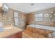 Bathroom featuring a tiled shower, soaking tub, vanity, and natural light from the window at 795 Superior St, Deltona, FL 32725