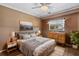 Comfortable bedroom featuring a bed, wooden dresser, neutral paint and decor, and natural light at 795 Superior St, Deltona, FL 32725