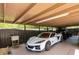 Garage with a white sports car, a black jeep, and a utility sink at 795 Superior St, Deltona, FL 32725