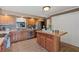 Kitchen with wooden cabinets, stainless steel appliances, tile floors, and a center island at 795 Superior St, Deltona, FL 32725