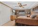 Comfortable main bedroom with a bed, dresser, ceiling fan, and large closet for storage at 795 Superior St, Deltona, FL 32725
