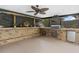 Covered outdoor kitchen with a built-in grill and bar area for entertaining at 795 Superior St, Deltona, FL 32725