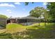 A pool with a screen enclosure is located in a large green backyard at 795 Superior St, Deltona, FL 32725