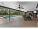 Spacious screened-in patio overlooking the pool with a fireplace and dining area at 795 Superior St, Deltona, FL 32725